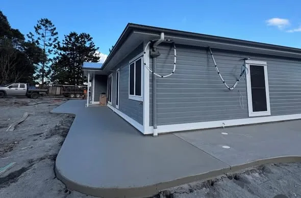 Home with wraparound concrete surround